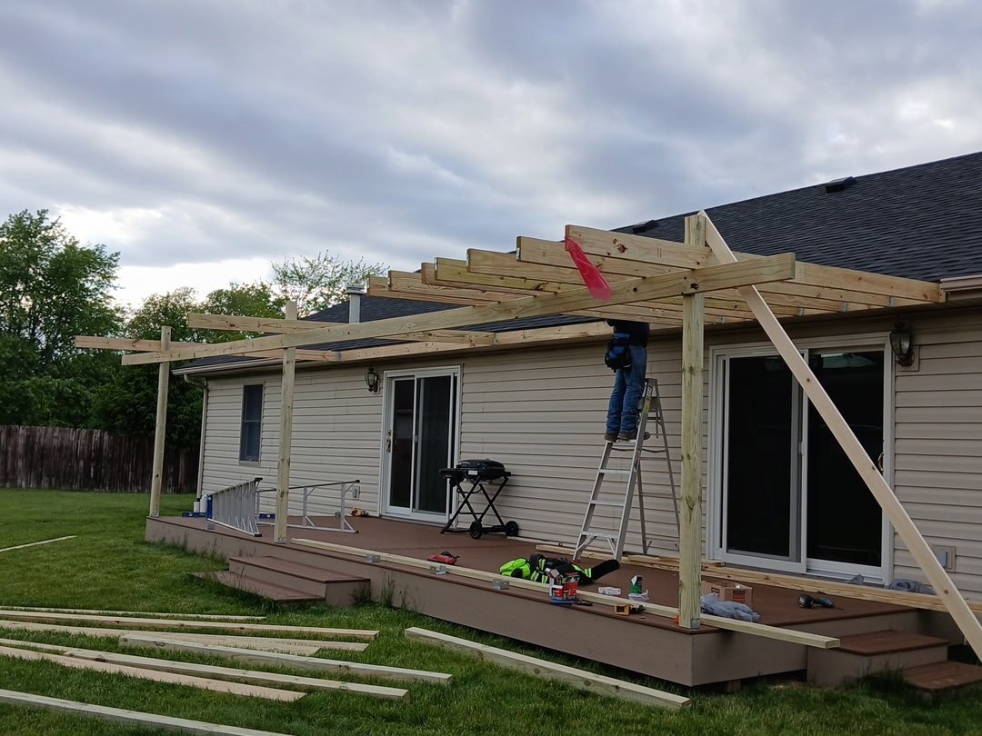 Gritstone crew framing a rear deck and pergola