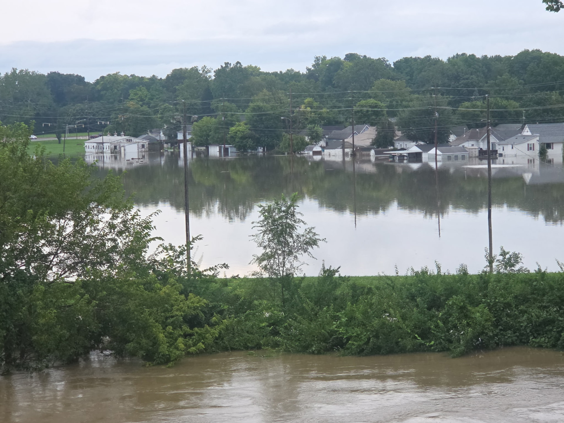 Indiana neighborhood flooded to the rooflines beside a swollen river