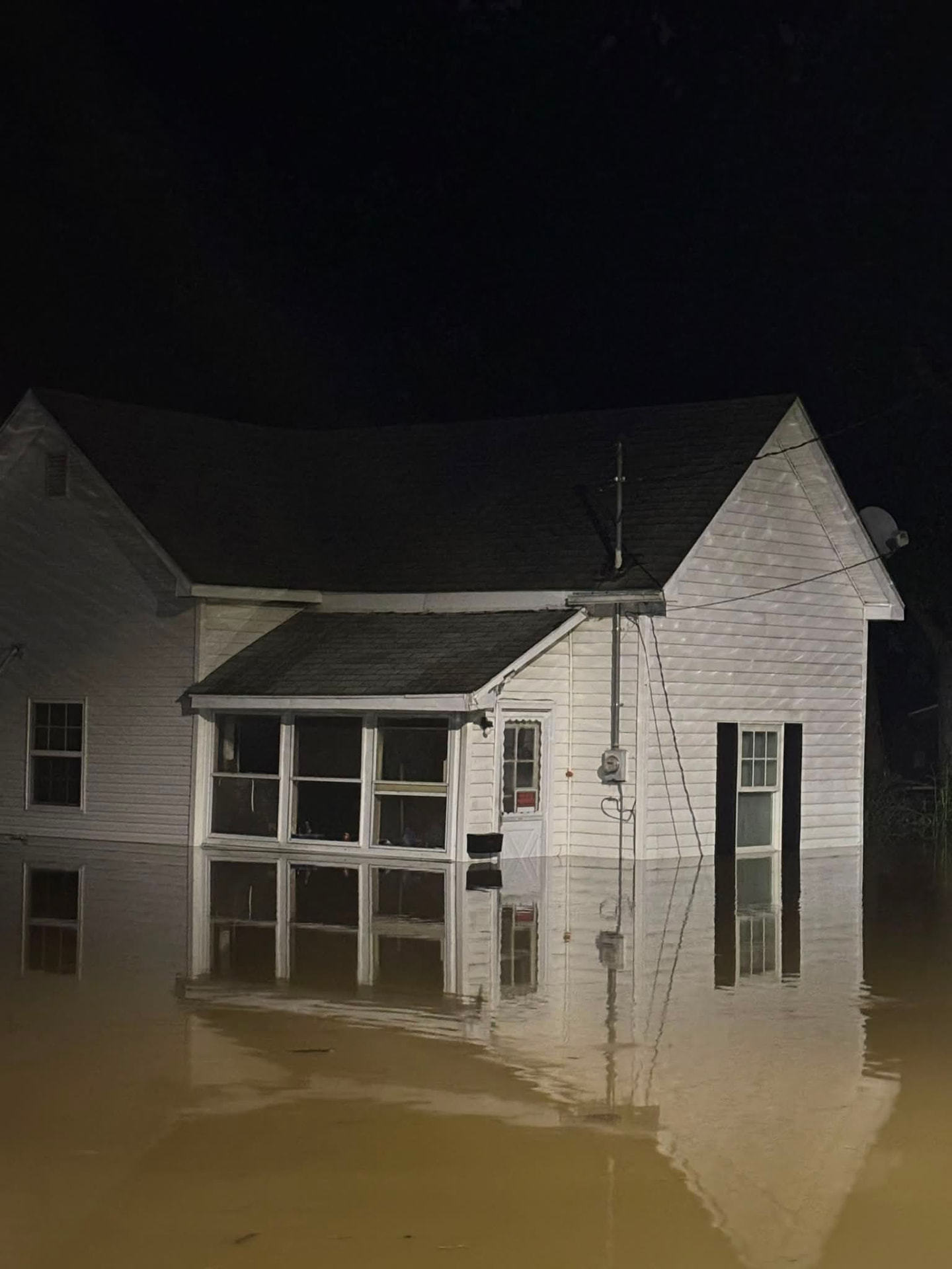 House surrounded by flood water at night in Indiana